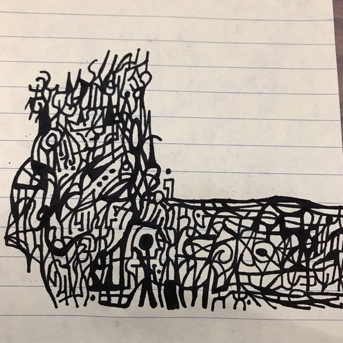 A dense, abstract black ink doodle drawn on lined notebook paper, featuring intricate swirls and patterns that resemble a chaotic scribble art piece.