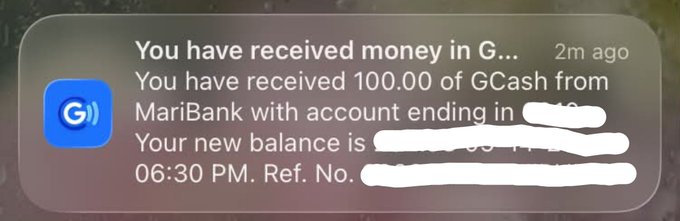 A smartphone notification from GCash showing a message that reads 'You have received money in G...', 'You have received 100.00 of GCash from MariBank with account ending in [redacted]. Your new balance is [redacted]. 06:30 PM. Ref. No. [redacted]', received 2 minutes ago.