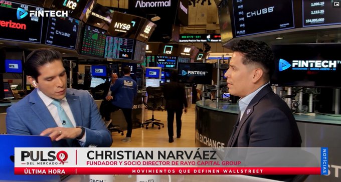 A television news broadcast on Pulso del Mercado featuring an interview with Christian Narváez, identified as Founder and Managing Partner of Rayo Capital Group, on the floor of the New York Stock Exchange with various ticker screens in the background.