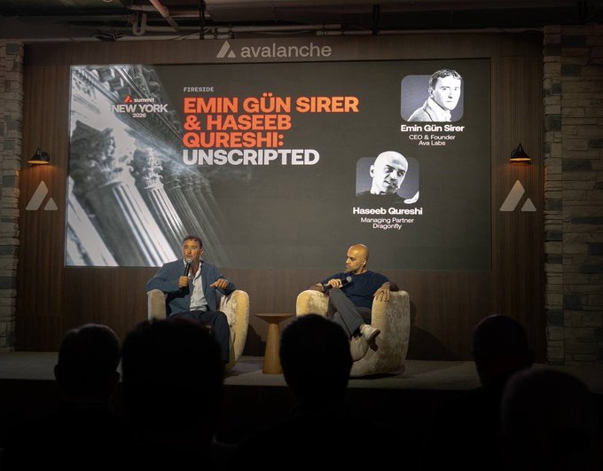 Two men sit in chairs on a stage in front of a screen reading 'avalanche NEW YORK 2025', 'EMIN GÜN SIRER & HASEEB QURESHI: UNSCRIPTED', identifying them as 'Emin Gün Sirer, CEO & Founder, Ava Labs' and 'Haseeb Qureshi, Managing Partner, Dragonfly'.