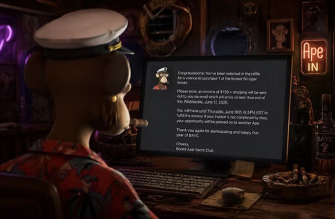 The image shows a cartoon monkey sitting at a desk with a computer monitor, typing on a keyboard. The monkey appears to be reading an email or message from someone named "Checks Your E-Mail" that contains information about a cigar box raffle event. The text in the email states that the winner will receive a cigar box for their birthday and is encouraged to share this exciting news with friends and family.