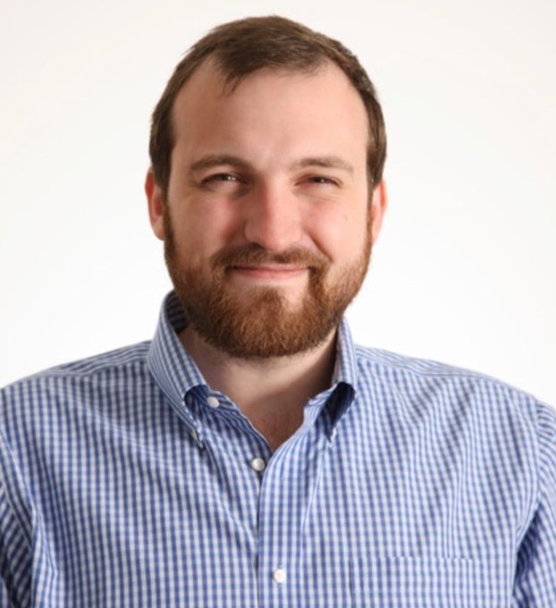 The image features a man with a beard wearing a blue and white checkered shirt against a plain background. The caption reads "LATEST: Charles Hoskinson says X has become too focused on drama, negativity, and tribalism," which is related to the content of the image.