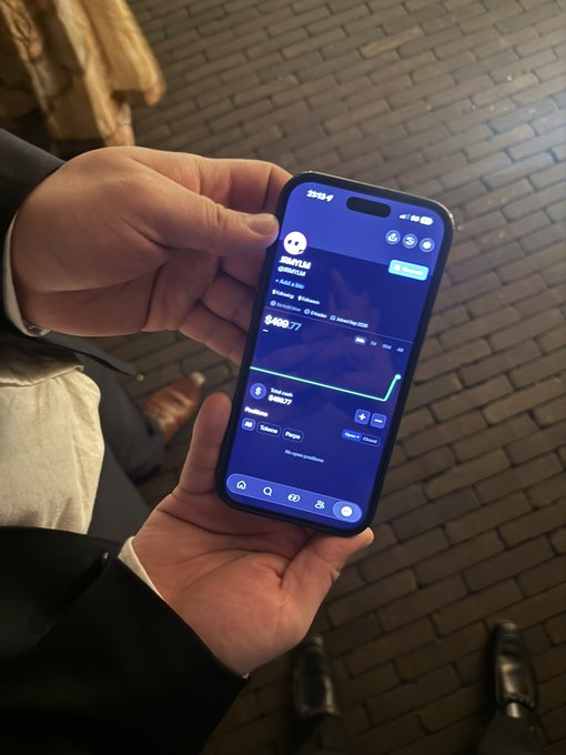 A person holds an iPhone displaying a Solana wallet app showing a meme coin called "chillguy" with a $489.77 portfolio value and an upward-trending green chart, illustrating the post's claim of an immediate 50x gain on the Chill Guy token that reportedly paid for a friend's law school semesters.