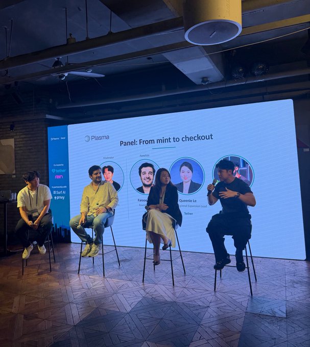 Four panelists sit on stools on a stage during a "From mint to checkout" discussion hosted by Plasma in Seoul, with the large screen behind them showing headshots and names including "Fawaz" and "Queensie Le (Tether Expansion Lead)," alongside sponsor logos for Rain, Tether, Privy.io, and Surf AI, reflecting the collaborative event described in the post.