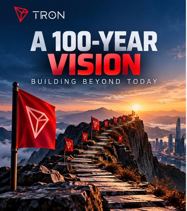 A promotional image for TRON with the text 'A 100-YEAR VISION BUILDING BEYOND TODAY', showing a mountain path lined with red TRON flags leading toward a city skyline at sunset.