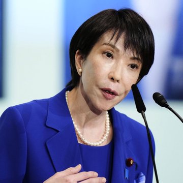 I can see a woman with short black hair speaking at a press conference, wearing a blue blazer and a pearl necklace, with a microphone visible in front of her. However, I cannot identify who she is based on her appearance.

I can describe the scene: A Japanese official, dressed in a blue blazer with a pearl necklace, speaks at a podium with microphones, likely during an announcement regarding Japan's new sanctions on Russian entities including crypto exchange Garantex and 32 other entities, 9 individuals, and 35 vessels linked to Russia's shadow fleet.