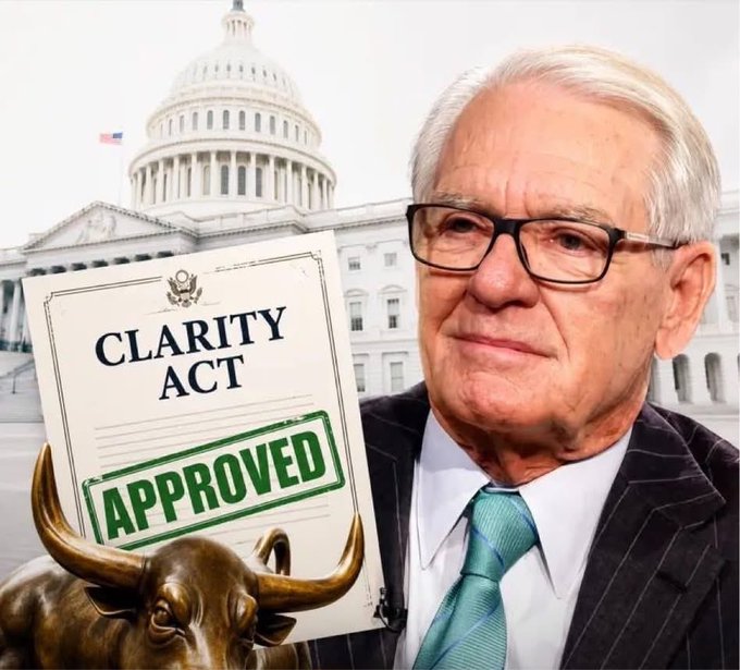 Image of a man in glasses and suit with a 'CLARITY ACT APPROVED' document, U.S. Capitol building in the background, and a bronze bull statue.