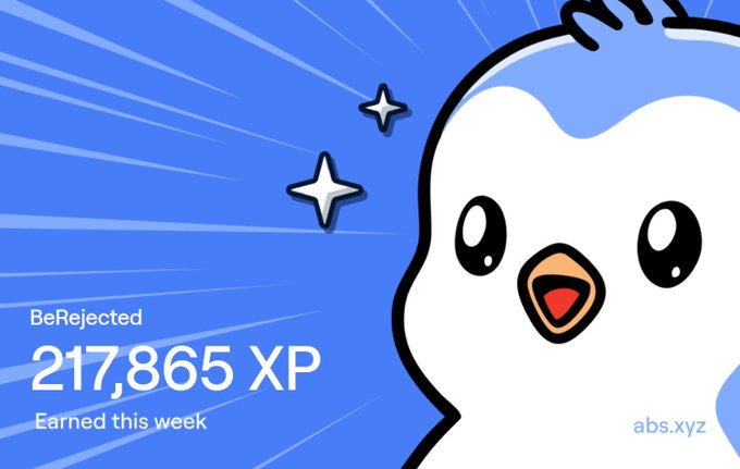 A Duolingo-style achievement screenshot featuring a cartoon bird character on a blue background, displaying 'BeRejected', '217,865 XP', and 'Earned this week' with the 'abs.xyz' watermark.