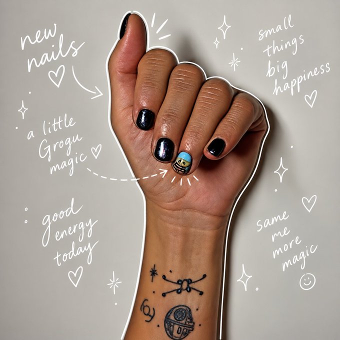 A close-up of a hand featuring black nail polish with one accent nail painted like a Grogu (Baby Yoda) character, accompanied by decorative text including 'new nails', 'small things big happiness', 'a little Grogu magic', 'good energy today', and 'same me more magic', plus small tattoos on the wrist.