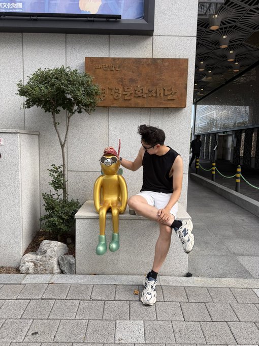 A person poses playfully beside a shiny golden monkey sculpture wearing sunglasses and a red headpiece, seated beneath a wooden sign reading "BURGUNDY" with Korean text at a Korean establishment.

The image humorously illustrates the post's mention of an "army" of bots, with the golden monkey figurine (adorned with sunglasses) serving as a visual mascot for the o1_bot "armies" mentioned, while the casual pose mirrors the lighthearted "aura farming" vibe described in the caption.