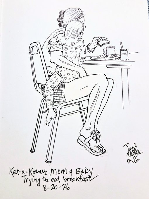 A black-and-white line drawing titled 'Kat-a-Korner Mom & Baby Trying to eat breakfast' dated 8-20-26, depicting a mother holding a baby on her lap while sitting at a table with food.