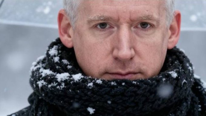 The image shows a man wearing a black scarf, with his face partially obscured by the scarf. The background appears to be a snowy landscape, suggesting that he might be experiencing cold weather conditions. The caption above the image reads "comments like these from smart traders always get me fired up. bc i'm a terrible, terrible trader ... but i am an inveterate early adopter." This statement implies that the man's facial expression and the snowy background are connected to his trading habits or experiences.
