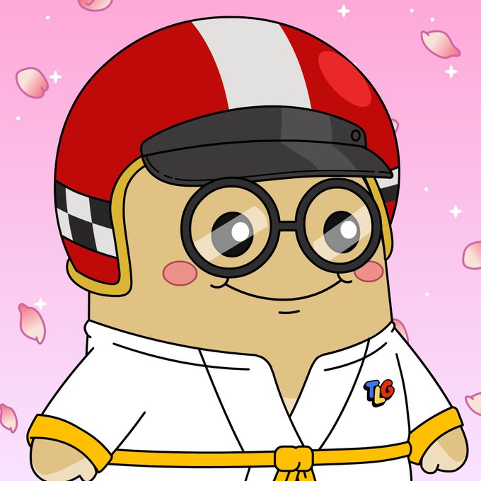 An animated digital illustration features a cute tan character wearing round black glasses, a red and white helmet, and a white karate gi with a yellow belt, set against a pink background with falling cherry blossom petals and a 'TB' logo.