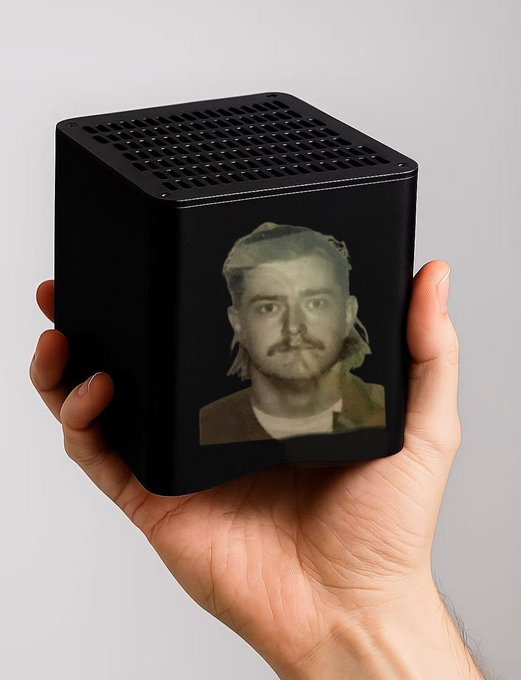 The image shows a person's hand holding a small black cube-shaped object with an image of a man on it, which appears to be a photo or a picture of someone else. The background of the image is white, making the black object stand out prominently. The caption provided in the image reads "GM y’all Big week Going to be at Istanbul Block Wk We have a new  Reviewing CyRunner applications". This suggests that there might be an event or competition related to reviewing and testing different applications on the app store, possibly focusing on games or other digital content.