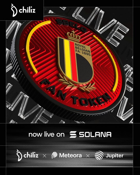 The image features a poster or advertisement for a fan token called "The Red Devils" that is being launched by a company named @BelRedDevils. The poster showcases a red and black coin with a yellow shield, which represents the fan token logo. The text on the poster indicates that the token is now live on @Solana and that it can be purchased using the Fan Token at $BELG. Additionally, there are mentions of other companies like @JupiterExchange and @MeteoraAG in the image description.