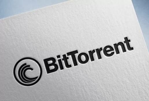 A close-up of a white textured surface displaying the BitTorrent logo and text in black.