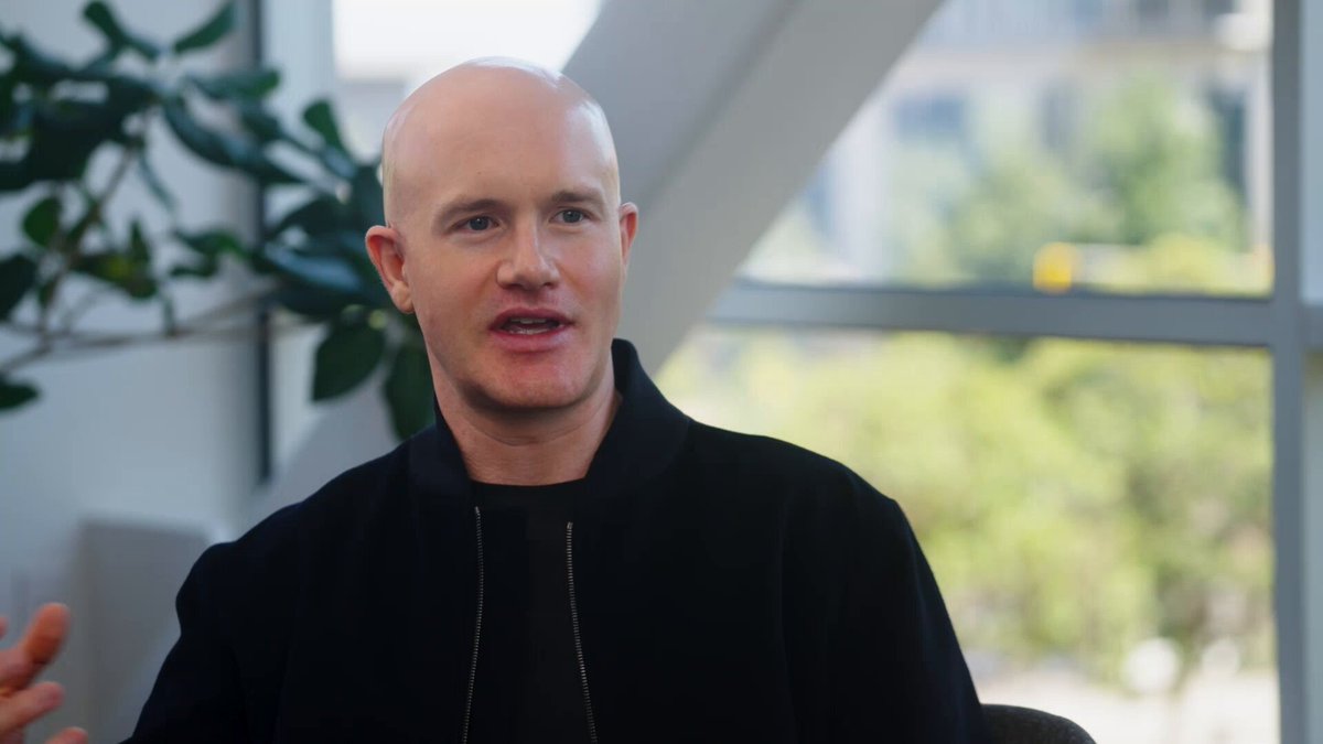 The image features a bald man wearing a black jacket, sitting down with his hands together as he speaks. He has a serious expression on his face while talking. In the background, there are some potted plants visible, adding a touch of greenery to the scene. The caption "Zcash." suggests that this could be an interview or discussion about cryptocurrency, which is likely what the man in the image is discussing with someone else.

The main focus of the image is on the bald man and his serious expression as he speaks, while the background elements provide context for the conversation taking place.