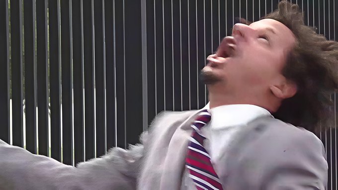 A man in a suit and striped tie throws his head back in dramatic exasperation, mouth open as if yelling, against a backdrop of vertical bars. The image humorously illustrates the post's theme of impatiently waiting for a surprise payout from Quip Network while seeing others cash in.