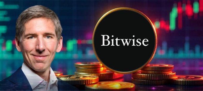 A smiling man, identified as Bitwise's CIO, appears alongside the Bitwise logo and gold coins over a stock chart backdrop, visually representing his optimistic outlook that crypto regulation will progress even without the CLARITY Act, thanks to potential SEC leadership under Paul Atkins.