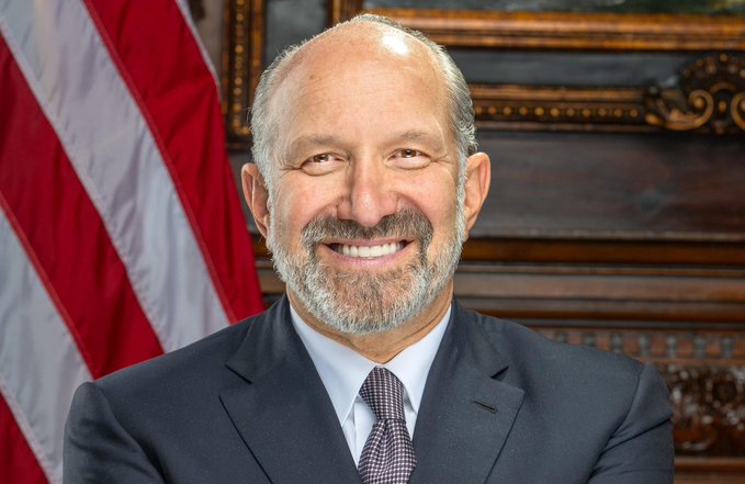 "Howards Law Firm" is a law firm that specializes in cryptocurrency matters. The man's name starts with the letter "H", which is also the first letter of his firm's name.