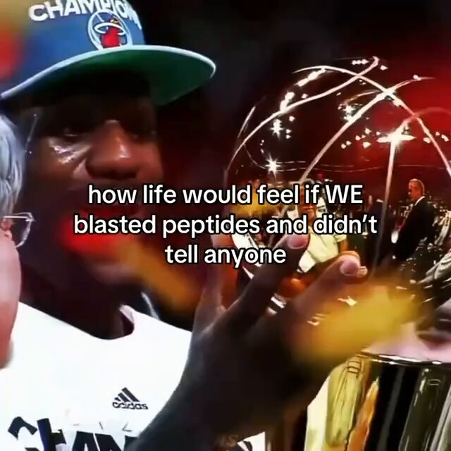 The image features a man wearing a blue hat, holding a basketball trophy with both hands while smiling at the camera. The caption below the photo reads "How life would feel if we WWE blasted peptides and didn't tell anyone".