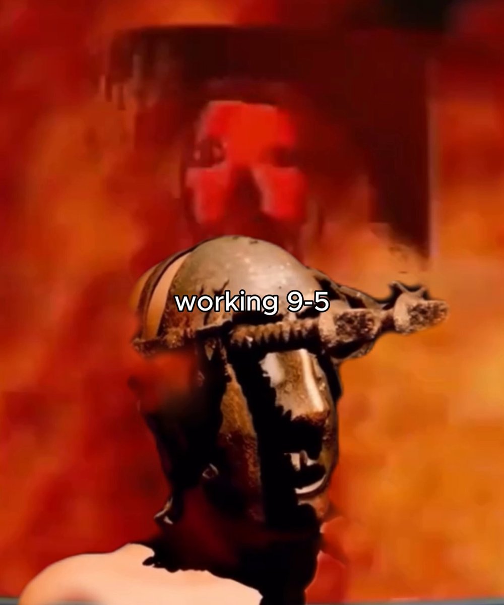 The image features a statue of a man with a helmet, possibly made from bronze or metal, placed against an orange background. The caption below the image reads "Working 9-5", which could be interpreted as a reference to the time when the statue was created or a message related to the work being done on it.