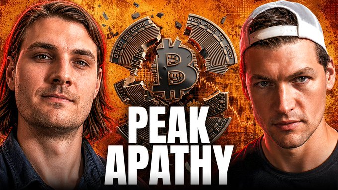 The image features two men with long hair, one wearing a baseball cap and the other a t-shirt, standing against an orange background that says "PEAK APATHY" written in white letters. The caption below them reads "No One Carries Bitcoin", which is related to the post about Peak Apathy.