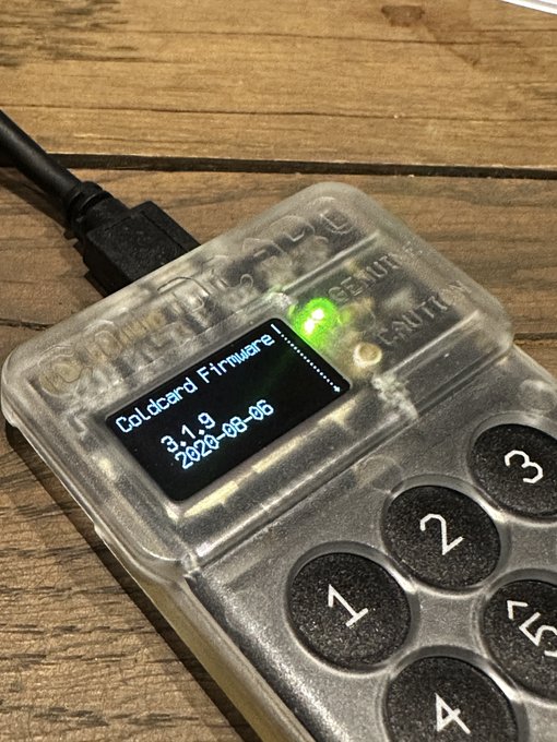 A transparent Coldcard Mk3 hardware wallet displays its firmware version "3.1.9" dated "2020-08-06" on its small screen, confirming the user's suspicion that the device is running dangerously outdated firmware well below the vulnerable 4.0.1–4.1.9 range mentioned in the Coinkite security advisory, while still showing a green status indicator that suggests it may have been temporarily powered on.