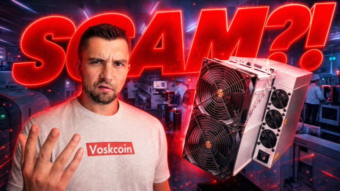 The image features a man wearing a red shirt with white text that reads "VOSKON" and another man standing behind him, who appears to be making a funny face or gesture. The background of the image shows an office setting with multiple computers and monitors on desks. The caption at the bottom of the image states "Bitcoin Miner Makers are SCAMMING YOU youtu.be/Tex4WCkd7WI".