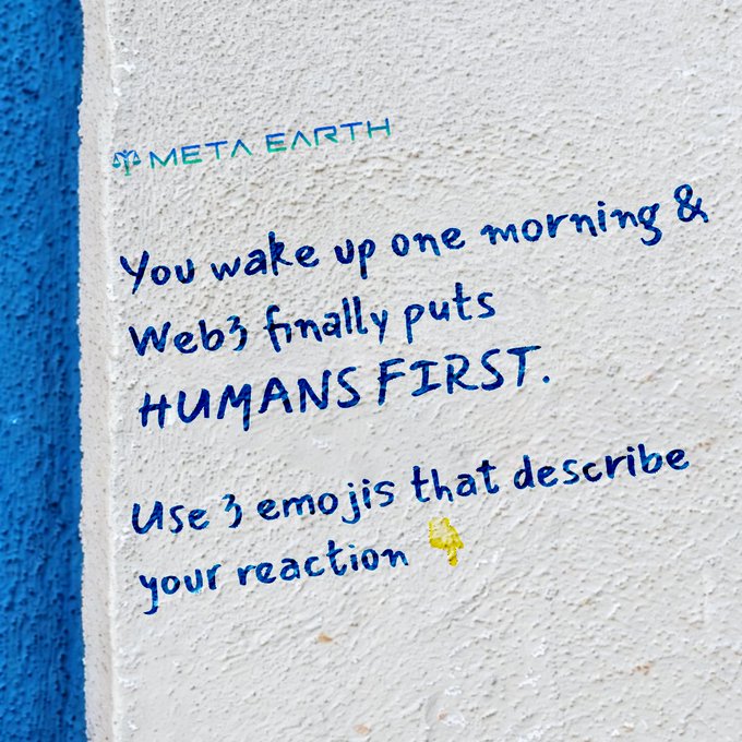 Graffiti-style mural on a white wall displays "META EARTH" branding and the message: "You wake up one morning & Web3 finally puts HUMANS FIRST. Use 3 emojis that describe your reaction 👇" The prompt invites viewers to react to Web3 becoming human-centered, aligning with the post's vision of a decentralized, user-focused future.