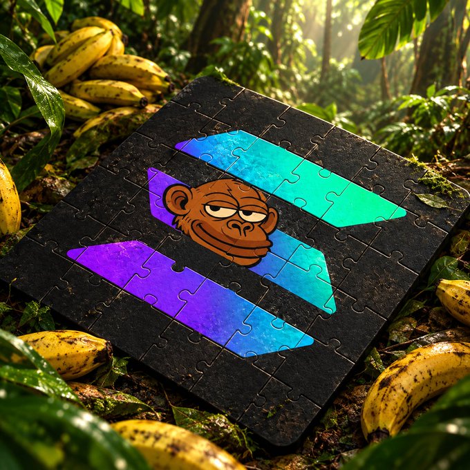 A completed jigsaw puzzle featuring a monkey face on a purple and blue gradient background, resting among bananas and leaves in a jungle setting.