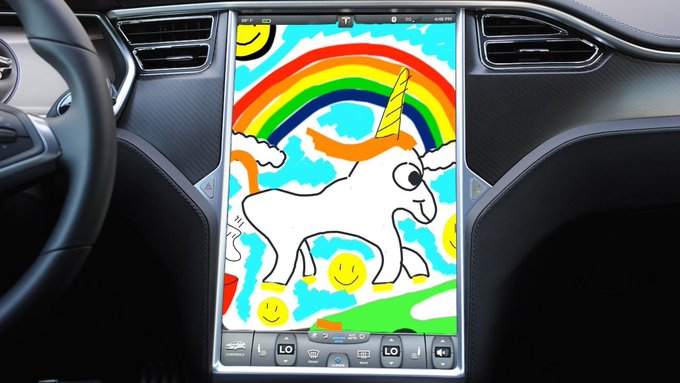 A child's colorful drawing of a unicorn with a rainbow on a digital touchscreen display inside a Tesla car dashboard.