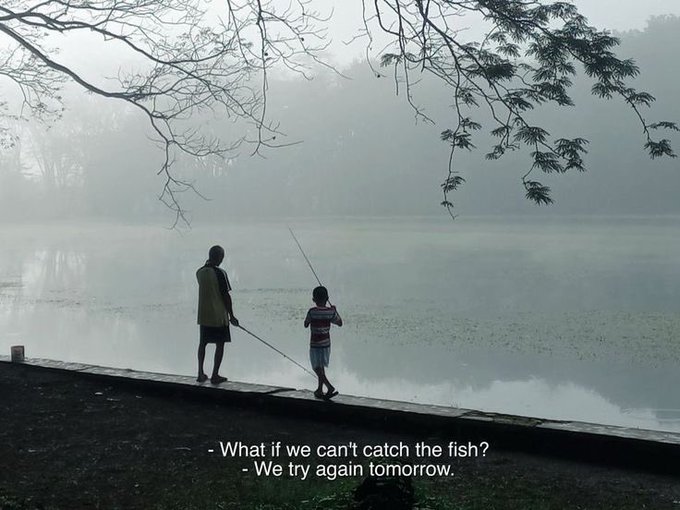 Two figures, likely a parent and child, stand on a misty lakeshore holding fishing rods, with the caption reading: "- What if we can't catch the fish? - We try again tomorrow." 

The image complements the post's optimistic, resilient tone by visually capturing patience and perseverance—themes of trying again align with the casual optimism of wishing followers a good morning and expressing a relaxed, hopeful Friday energy.
