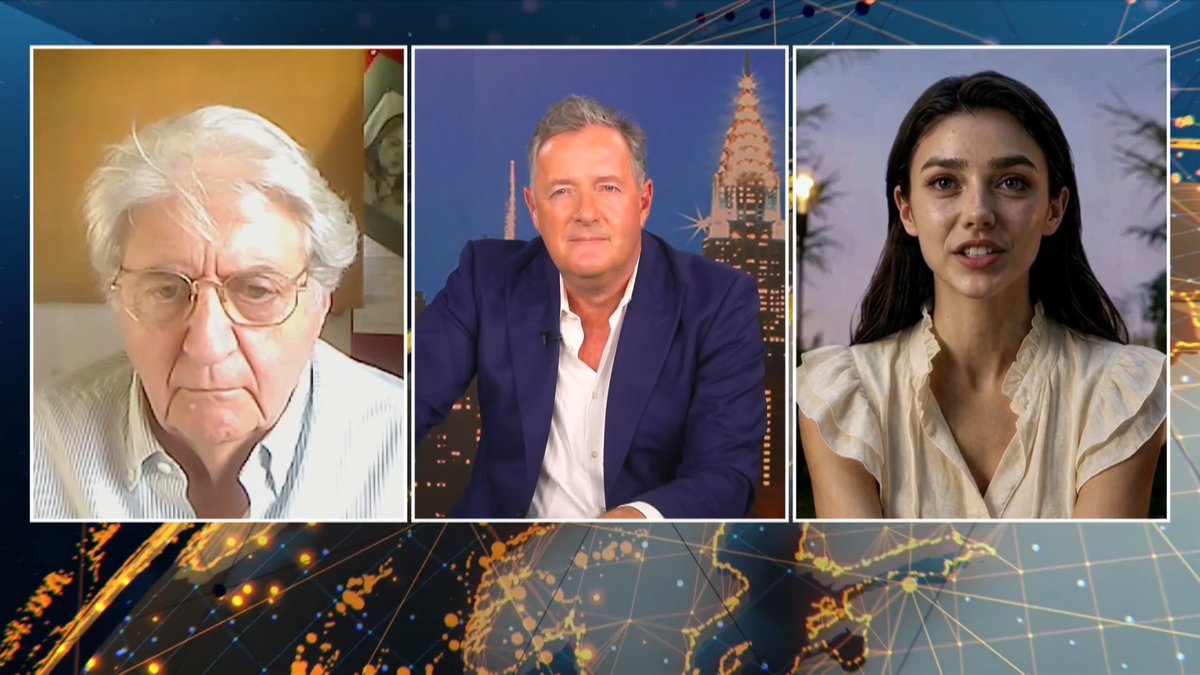 A split-screen broadcast shows three people in separate panels: an older man with white hair and glasses on the left, a man in a blue blazer against a cityscape backdrop in the center, and a woman in a ruffled blouse on the right.