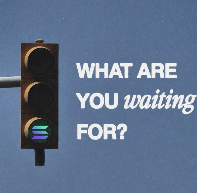 A traffic light against a blue sky with the illuminated text 'WHAT ARE YOU waiting FOR?'