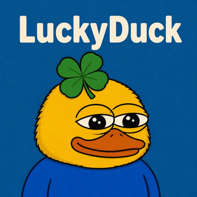 A cartoon illustration of a yellow duck with a green four-leaf clover on its head, wearing a blue shirt, with 'LuckyDuck' text above.