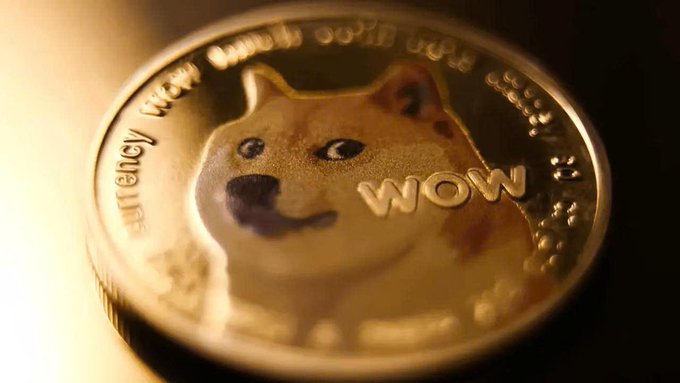 A close-up of a Dogecoin-style gold coin featuring the Shiba Inu dog mascot, with the text “WOW” and “currency” visible. The image illustrates the post’s announcement about Dogecoin Labs and its goal to make DOGE usable as everyday money.
