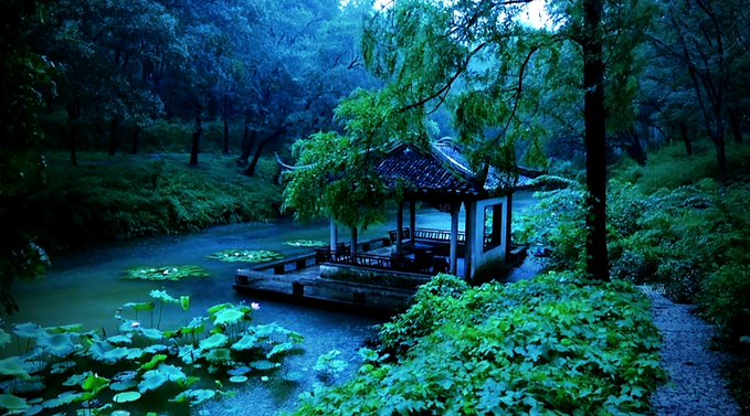 A serene, misty scene of a traditional East Asian pavilion with curved tiled roofs, situated on a pond surrounded by lush green trees, lotus plants, and lily pads at dusk.