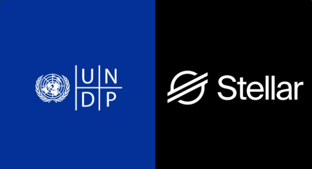 The image displays the UNDP logo alongside the Stellar logo, representing the partnership between the United Nations Development Programme and the Stellar blockchain network. This visual ties to the announcement of their collaboration moving from pilot to production, highlighting Stellar's real-world utility in reducing aid distribution costs through blockchain-based payments.
