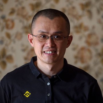 A smiling man with glasses and a dark polo shirt featuring the Binance logo stands in front of a floral-patterned background. The image likely represents RYKER, the crypto trader mentioned in the post who predicts Ethereum will surge from $1,260 to $10,000.