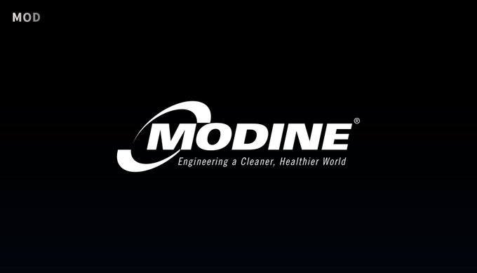 The image shows a logo for Modine, an engineering company that specializes in cleaning products. The logo features a white circle with a black outline, which represents the Modine logo. The text "Modine" is written in white letters above the logo. Below the logo, there are two lines of text that read "Engineering & Cleaner World". These lines contain the Modine company name and its slogan, "modine.engineer.cleaning.healthier.world".