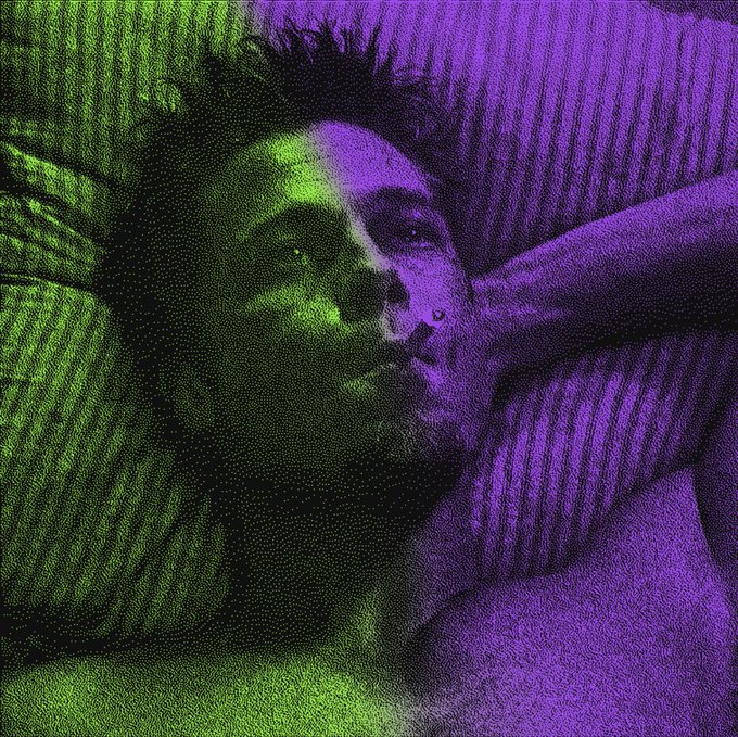 A person rests their head against a striped pillow, bathed in moody purple and green lighting that gives the scene a dreamy, isolated atmosphere—mirroring the contemplative "me against the world" tone of the caption. No visible text, numbers, or names appear in the image.