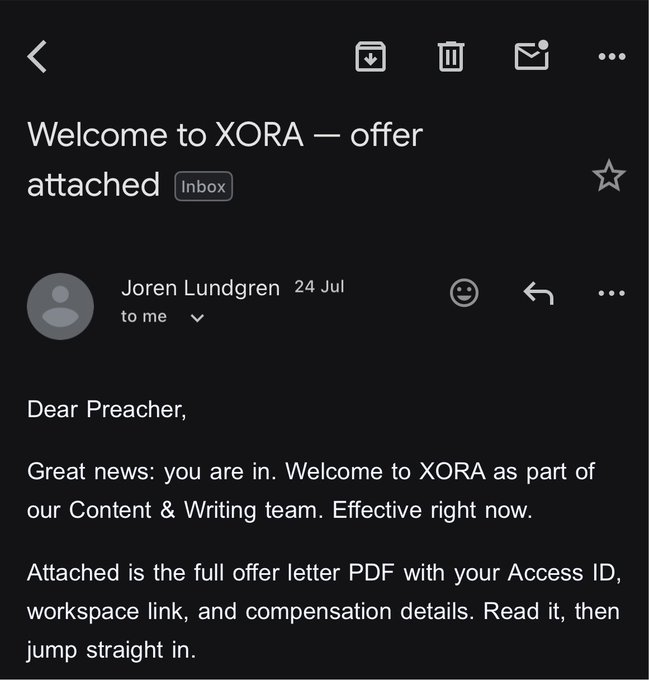A screenshot of an email from Joren Lundgren dated July 24, with the subject "Welcome to XORA – offer attached," notifying "Preacher" of acceptance to XORA's Content & Writing team and referencing an attached offer letter with access details—directly illustrating the poster's surprise discovery of this acceptance email days later.