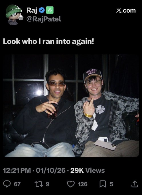 A screenshot of an X.com post by 'Raj' (@RajPatel) captioned 'Look who I ran into again!' showing two young men posing together at night, posted 01/10/26.