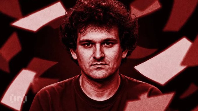 A red-tinted portrait photograph of a man with curly hair, with scattered paper-like shapes in the background and an 'inn' watermark in the corner.