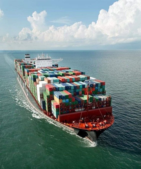 A massive container ship sails across the open sea, its hull stacked high with multicolored shipping containers, symbolizing long-haul logistics and stability. The image visually reinforces the post's theme of "$SHIP" tokenomics being built for endurance, with the vessel representing steady, sustainable transport over quick turns.