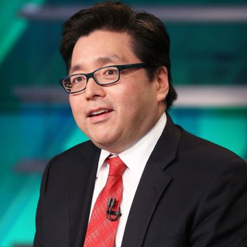 A man in a dark suit with a red tie and glasses speaking during what appears to be a television broadcast.
