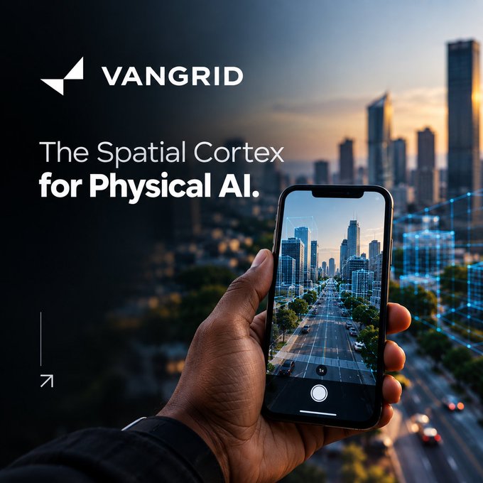A hand holds a smartphone displaying a city street view against a blurred cityscape background, with the text 'VANGRID' and 'The Spatial Cortex for Physical AI' in the upper left corner.