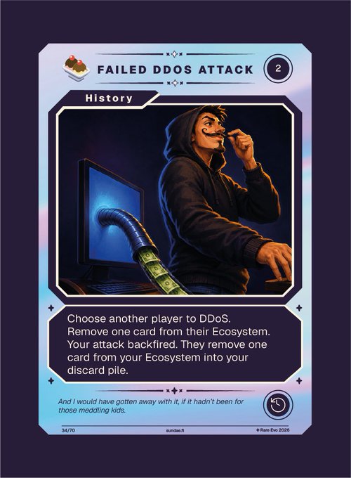 A trading card titled "FAILED DDOS ATTACK" from a Cardano-themed game, numbered 34/70, depicts a cartoon hacker in a hoodie being thwarted by a computer vacuuming up money. The card's text reads: "Choose another player to DDoS. Remove one card from their Ecosystem. Your attack backfired. They remove one card from your Ecosystem into your discard pile." The card connects to the post by showcasing a fun, accessible gaming experience designed to onboard newcomers into the Cardano ecosystem through themed strategy cards.