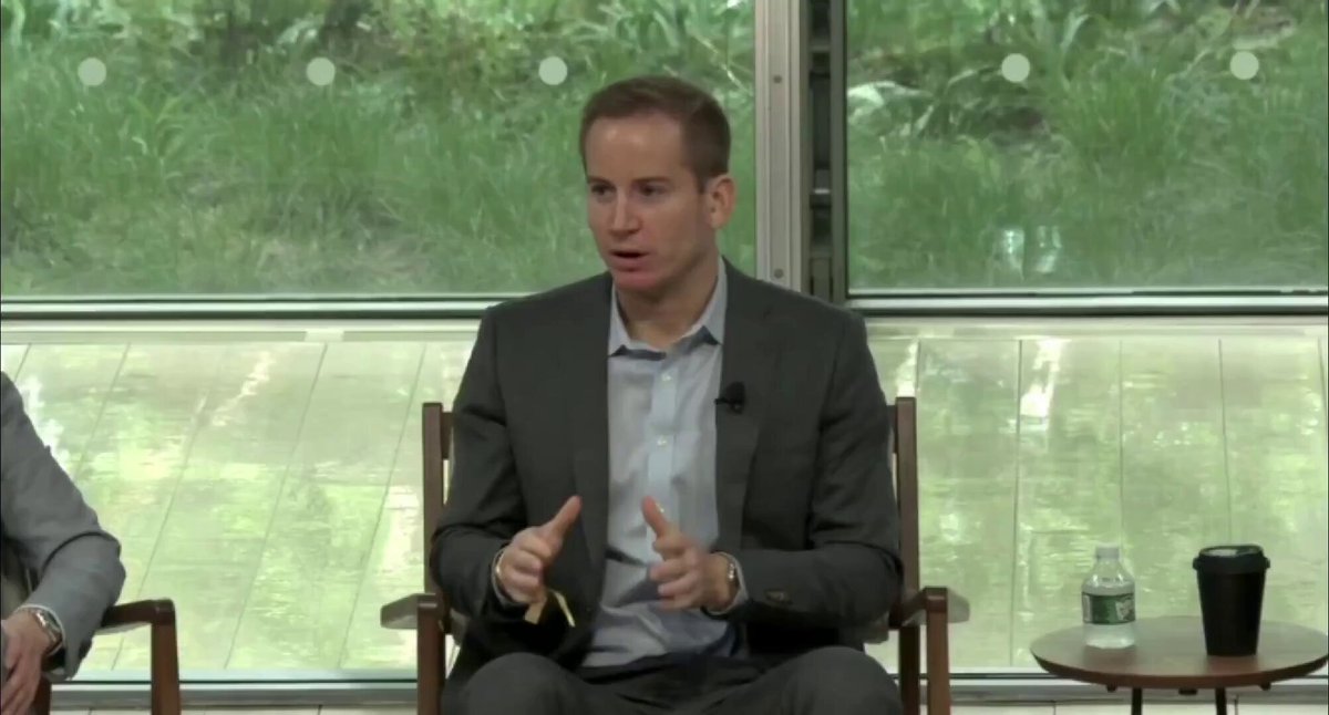 The image shows a man sitting in a chair, wearing a suit and giving a speech or presentation. The background features a window with green plants outside, providing a natural element to the scene. There are two other people present in the room, one on each side of the main subject. A cup is also visible near the right edge of the image.

The post that accompanies this image discusses Bitcoin and its potential impact on traditional financial systems. The man giving the speech mentions that Bitcoin holders should not be worried about quantum, which could potentially affect the security and stability of Bitcoin transactions. This statement suggests that while there are concerns surrounding the use of Bitcoin in certain situations, it is unlikely to have a significant negative impact on the overall value or functionality of the cryptocurrency.
